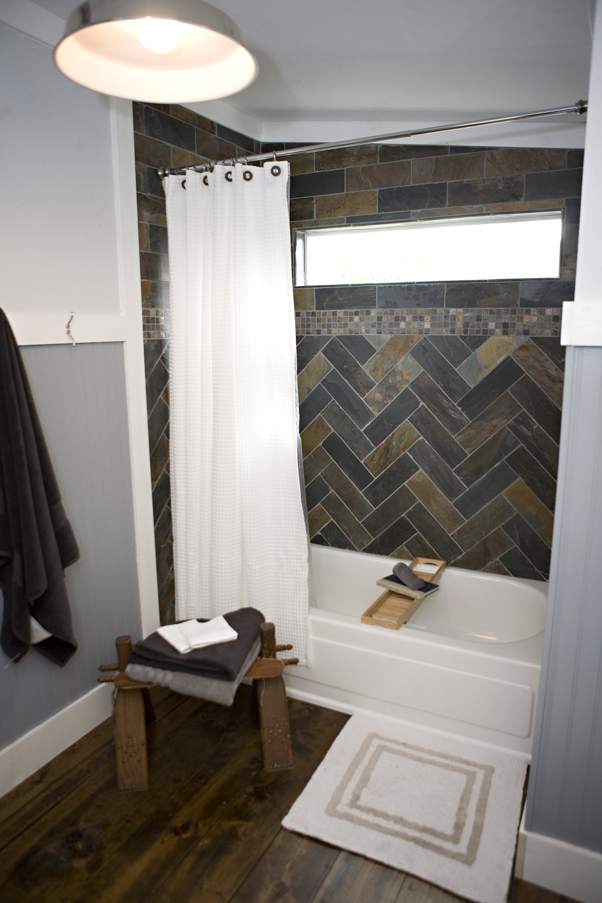 slate tile, manly bathroom. herringbone tile, wood floor, beadboard in bathroom