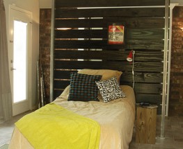 WALL/HEADBOARD ALLOWS ROOM TO DO DOUBLE DUTY