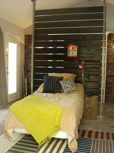 WALL/HEADBOARD ALLOWS ROOM TO DO DOUBLE DUTY